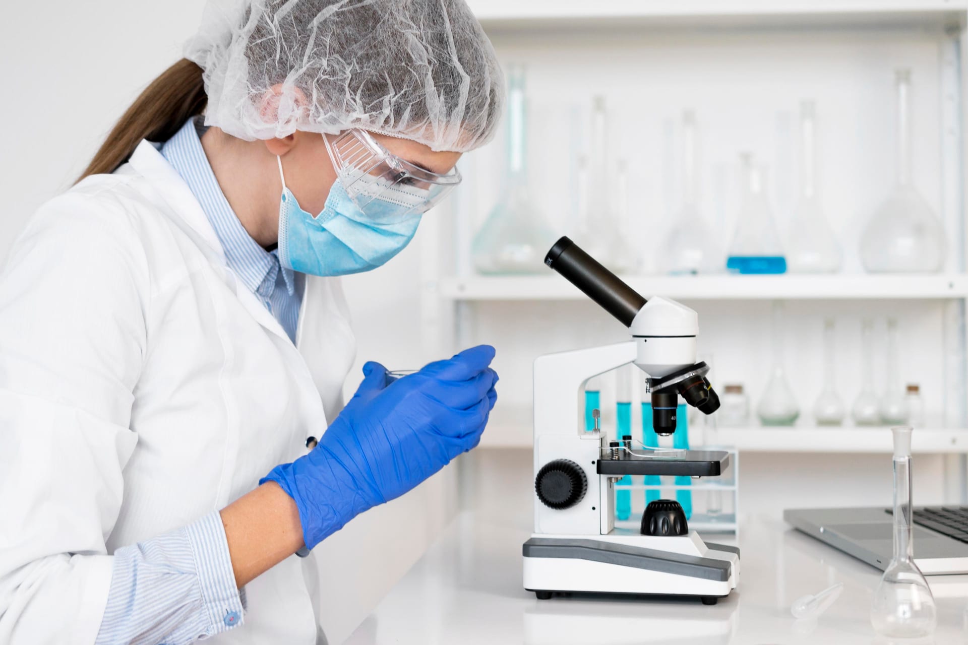 Embryologist at a microscope inside an IVF clinical laboratory
